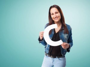 (A woman can be seen holding a 3D sign letter in her hands)