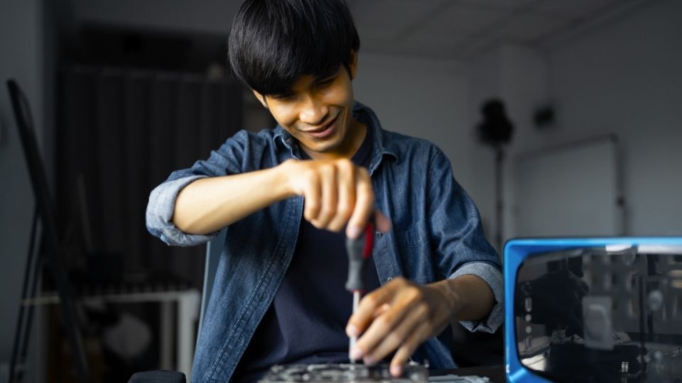 In the image a man can be seen in the process of making a logo sign backlit)
Backlit logo sign