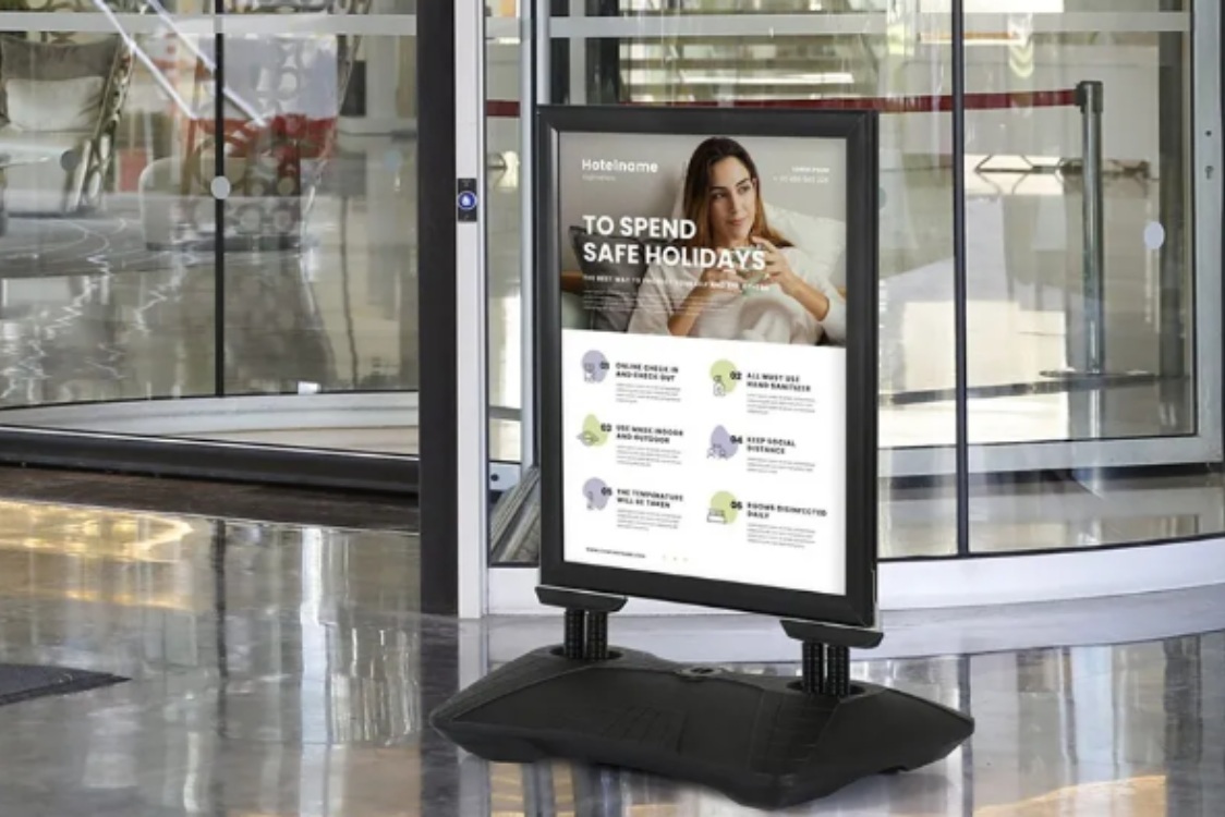 A large informational sign on a stand positioned in a lobby area, providing guidance to visitors. weatherproof outdoor signs
