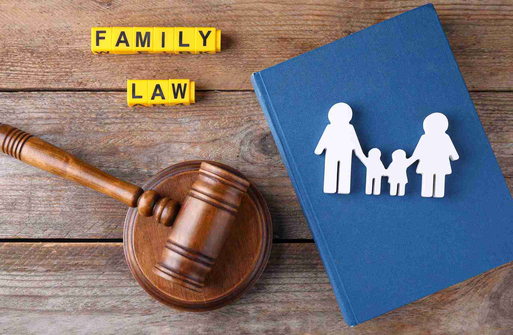 Gavel with family wooden puppets showing family law concept.